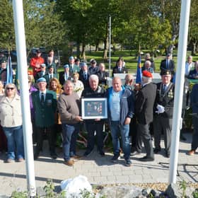 Mike Walsh of the Private James Coady Bunratty Monument Project Group presents members of the Coady family with a commemorative plaque to be erected in Pte. Coady's hometown of Carrick-on-Suir