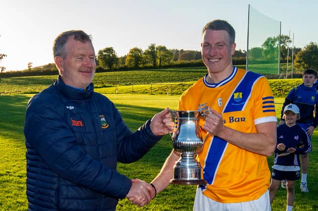 Conor O'Dwyer presents the cup to Boherlahan/Dualla captain Brian Carrigg