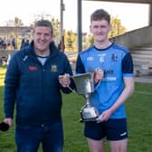 Moyle Rovers captain Jack Boland received the cup from Stephen Gleeson, PRO of the County Football Board