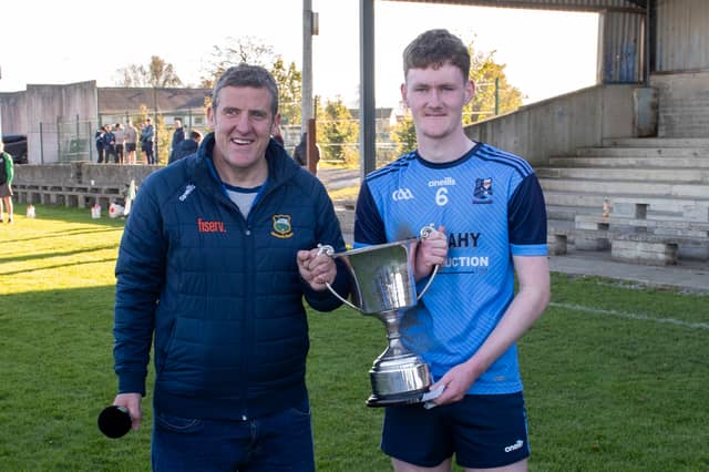 Moyle Rovers captain Jack Boland received the cup from Stephen Gleeson, PRO of the County Football Board