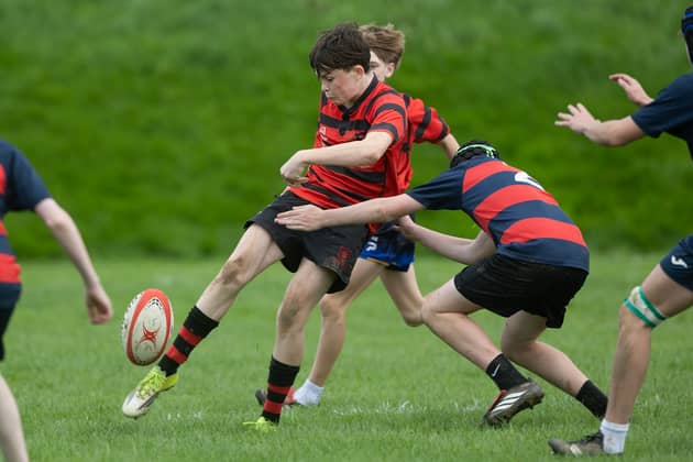 Clonmel High School's Jack Dillon tries to get a kick away in the Mungret Shield Under 16 match against Villiers School