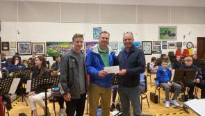 Visitors from America make a donation to Banna Chluain Meala