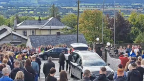 VIDEO: Pallbearers guide white coffin into church for Nicole Murphy's funeral