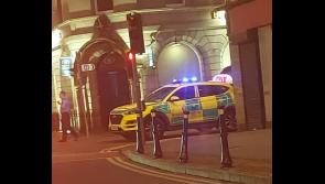 Stricken pedestrian being attended to by emergency services on main street of big Tipperary town