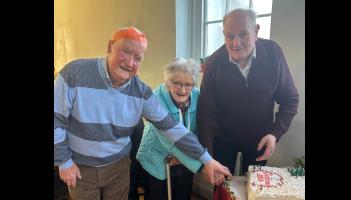 Maisie Ryan cutting the cake at a Senior Citizens' Christmas Party in Premier County
