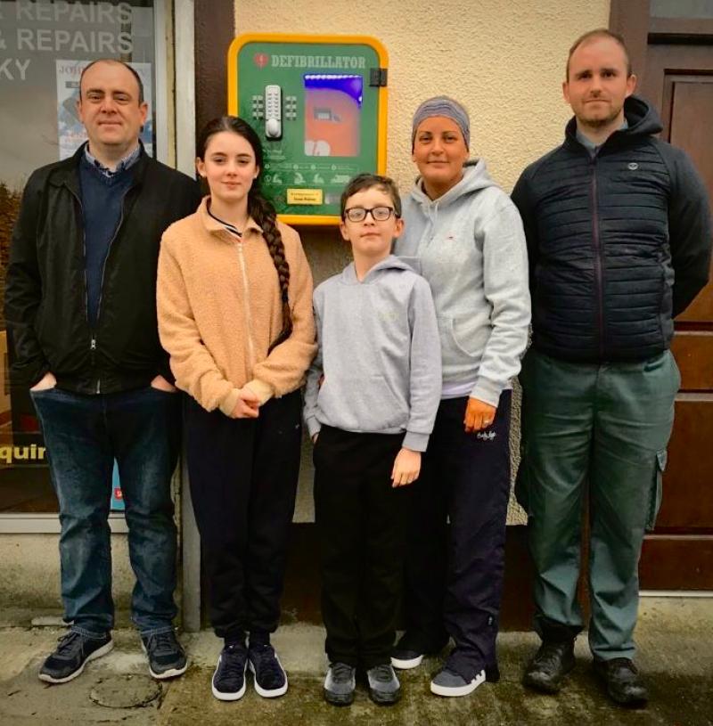 Stefani Neeson, Alex Neeson & John Nolan, pictured with Justin Neeson  and his wife Rachel with the AED mounted on the wall behind them at the Dehreen, Thurles  