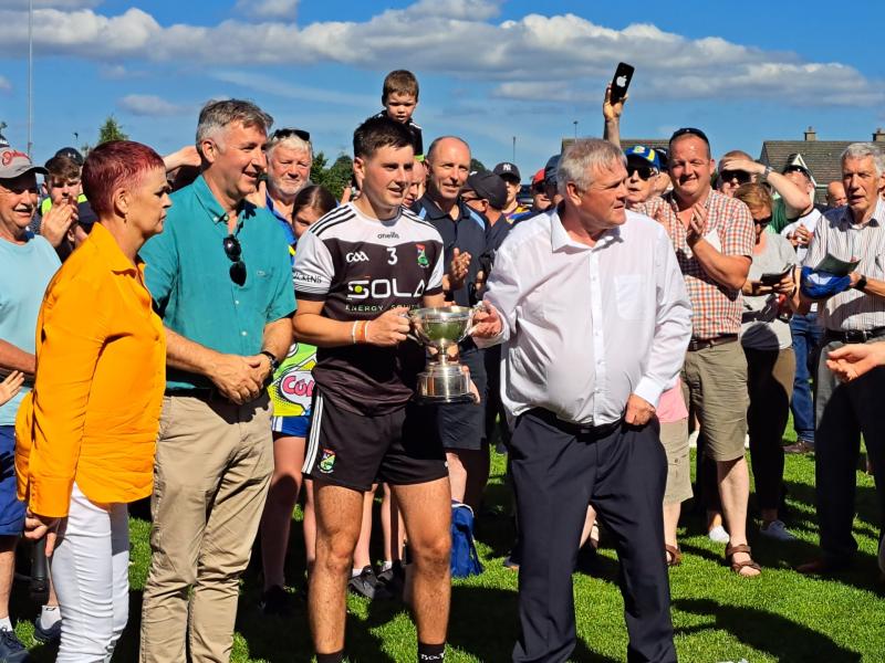 JK Brackens captain Tom Murphy accepts the mid senior hurling title for JK Brackens after their first ever victory this afternoon in Boherlahan