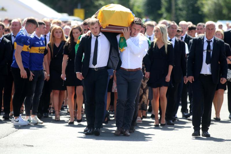 Club colleagues carry Dillon Quirkes remains to the church on Tuesday morning