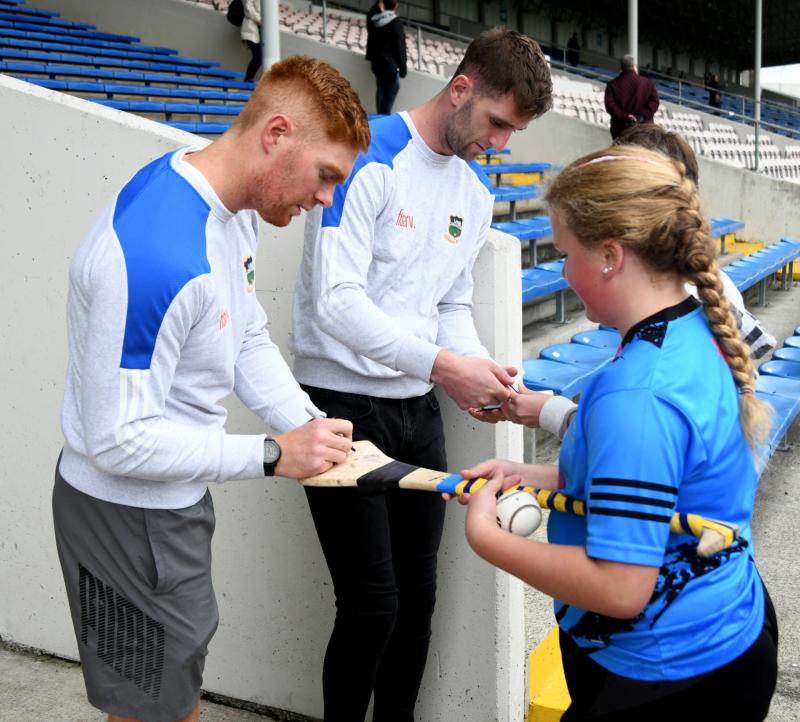 Tipperary players Jason Forde and Barry Heffernan  sign autographs at the big day