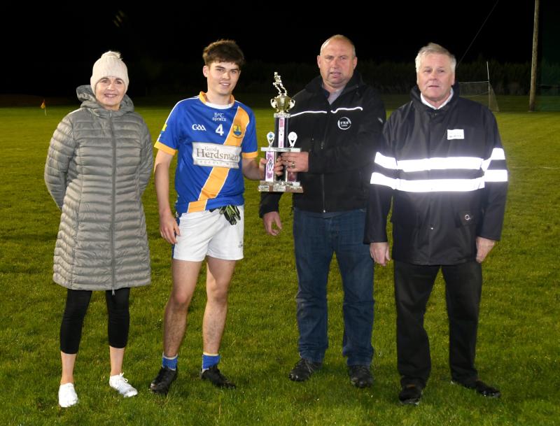 Cormac Casey of Boherlahan Dualla is presented with the Joe O'Sullivan sponsored Mid U19 B Football trophy by Mid Board Vice Chairman Martin Bourke. Also pictured is Mid Secretary Catherine Dunne and 