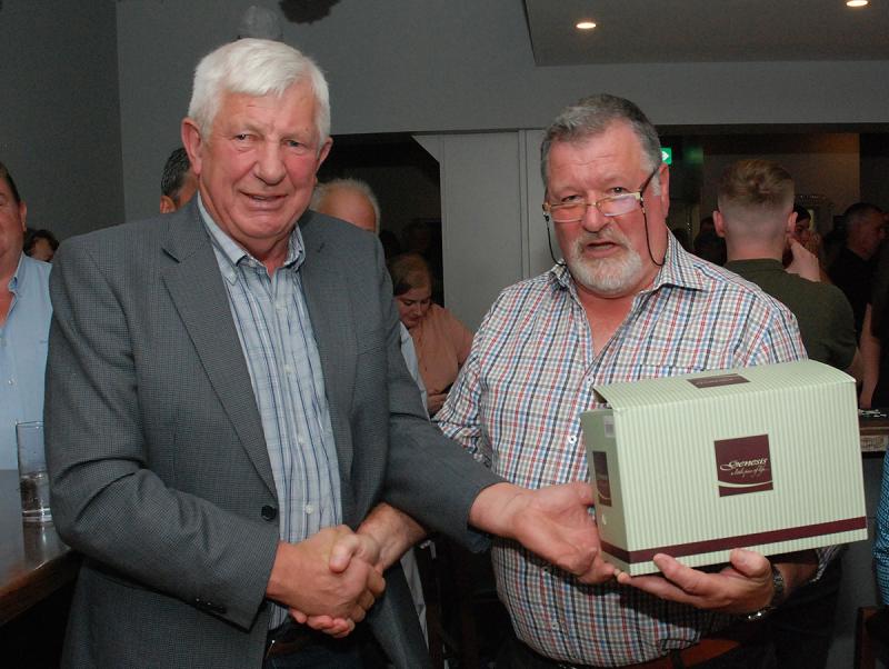Postman Michael Thompson retired from service and received a presentation from  John Culleton to mark the occasion.