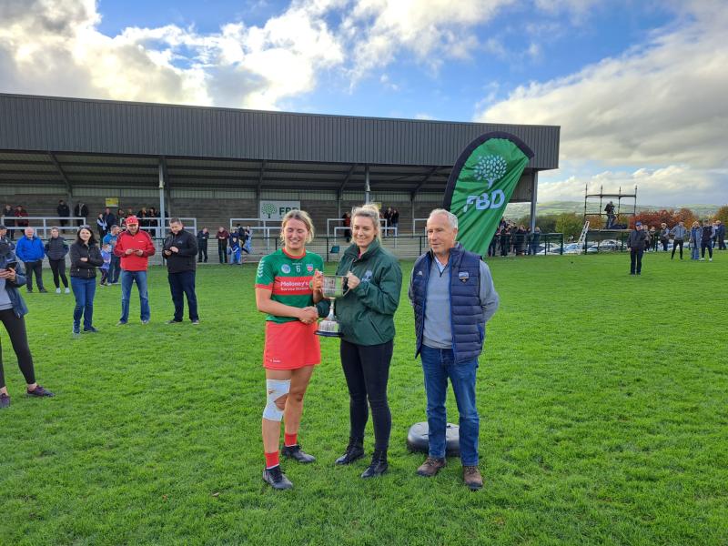 Mags Fanning of FBD Insurance presents the cup to Drom-Inch captain Mairead Evistom after the final this afternoon