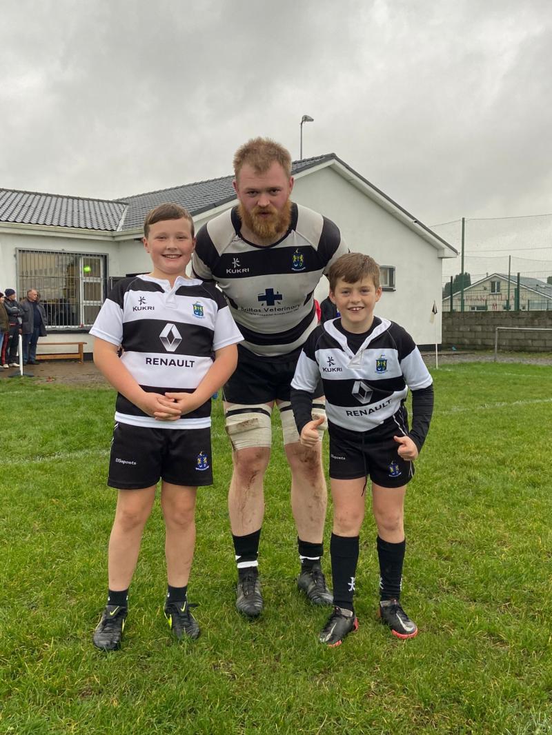 Thurles Captain Luke Kelly with his two proud mascots Murt Dillon and Tommy Stapleton  