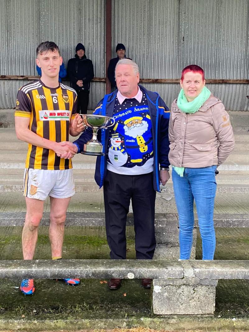 Keith Ryan receives the cup from Joe O'Sullivan and Catherine Dunne, Chairman and Secretary of the Mid Board