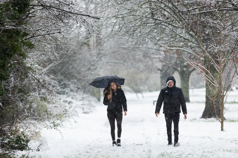 BEAUTIFUL SCENE:   A couple takes a walk in a Tipperary park during  the snowstorm 