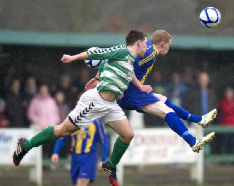 Dave Dineen (Park United) and David Slattery (St. Michaels) flying through the Cooke Park air on Sunday last.