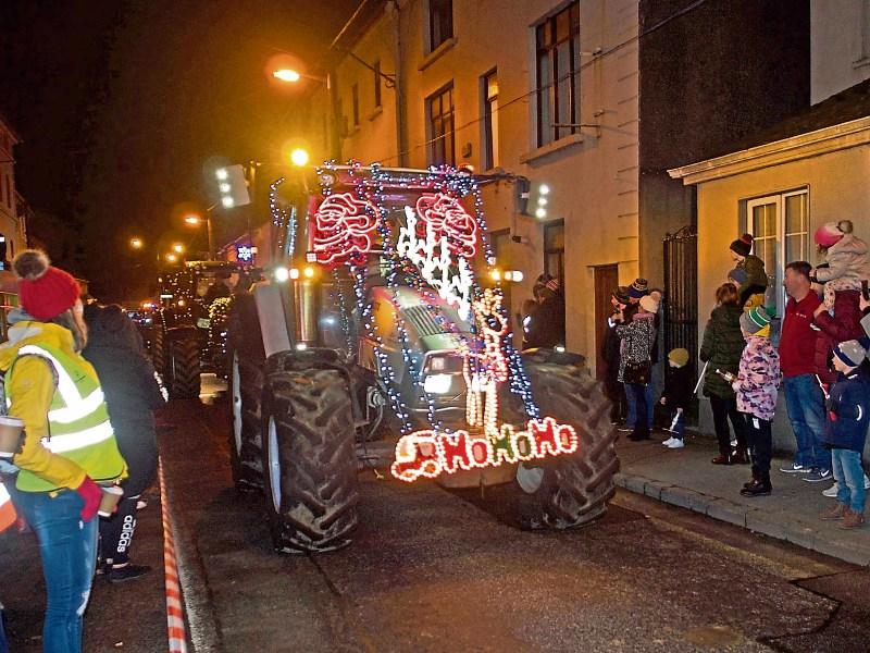 Parade of tractors decorated with 100,000 fairy lights dazzle the night sky in Co. Tipperary town 