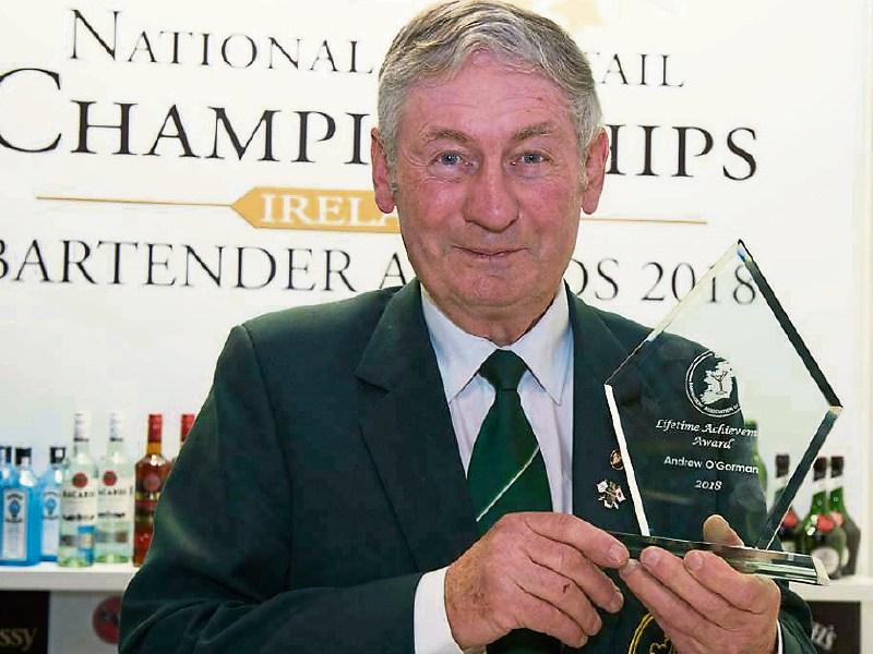 Tipperary barman Andrew O'Gorman raises a glass after he receives lifetime award