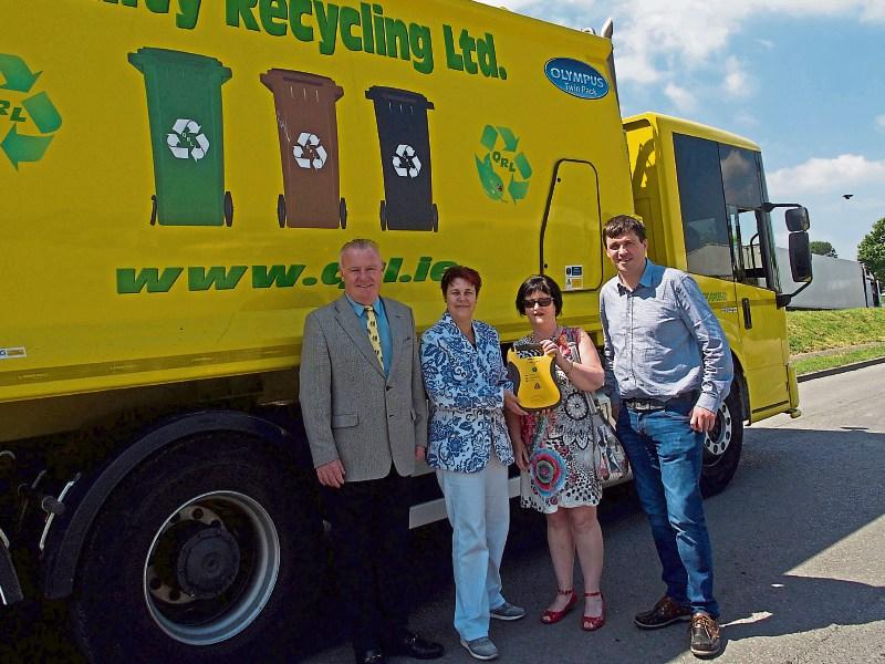 Cllr Kieran Bourke with Dr Sabine Eggers and Anne Walsh of the Ahenny and Faugheen Defibrillator Project receiving the defibrillator from Tim Ryan of Quality Recycling. 