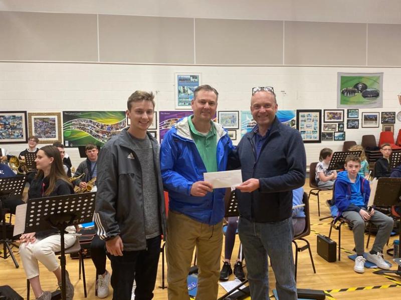 Visitors from America make a donation to Banna Chluain Meala