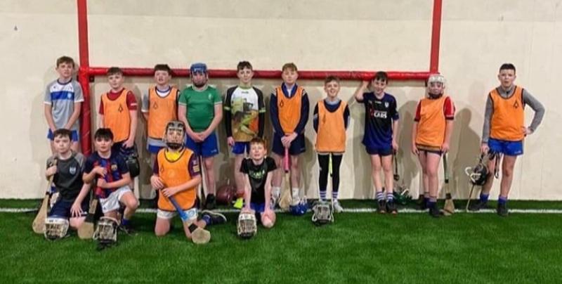 Young Fourmilewater hurlers give the new Ballymacabry astro turf the thumbs up!