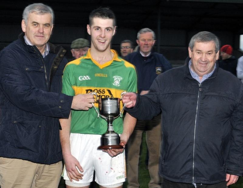 Martin Sadlier (Clonoulty-Rossmore captain) pictured accepting the new Tony Brennnan Cup from Tom English (West Board Chairman) after the West Tipperary under-21A hurling final in Golden last Sunday. Pictured on the left representing the sponsors O'Dwyer Steel is Matthew Ryan.