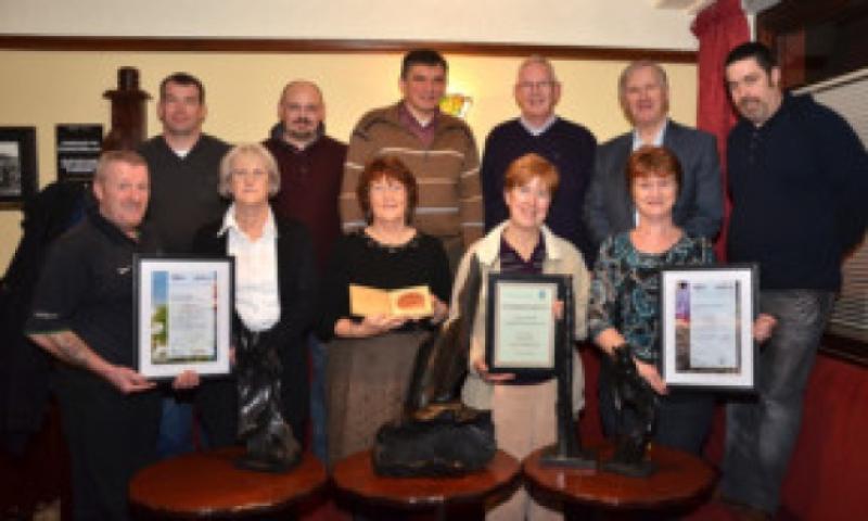 Roscrea Tidy Towns show off some of the many Awards received in 2013Back row L/R: Ray Ryan, Alan Shovelar, Gintnist, Dick Conroy, Dennis Ryan C/M, Neil Guerin,Front l/R: Chick Conlon, Mary Heffernan, Eileen Doherty Secretary, Rose Crofton Treas, (Mary Conroy CAVA Community Person of the Year).