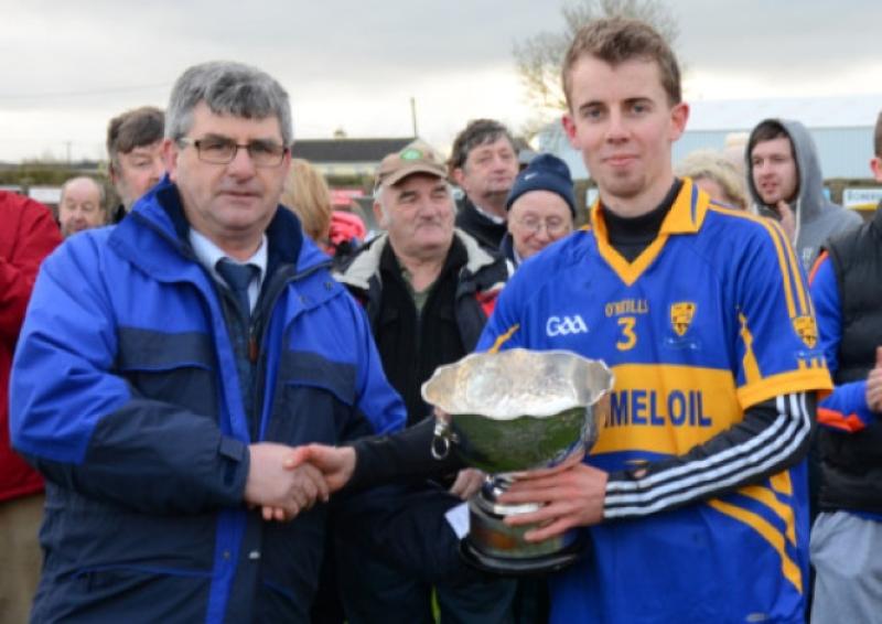 Kilsheelan/Kilcash Under 21 A hurling captain David Corcoran accepts the cup from South Board chairman Michael Cooney after his sides historic win in the South Championship on Sunday last.