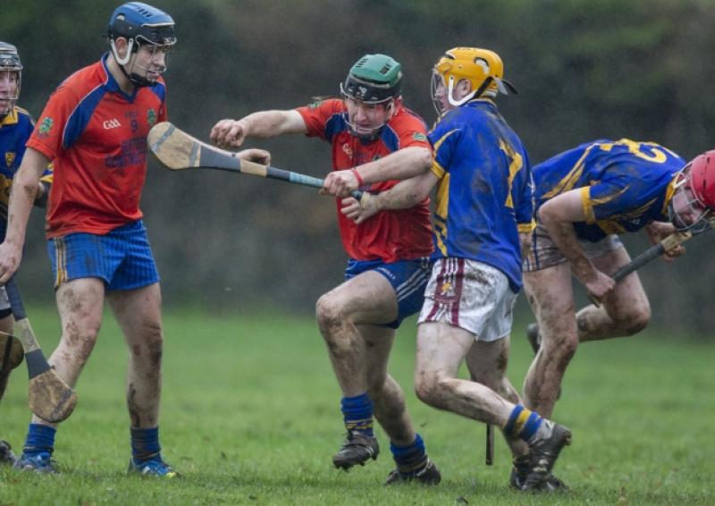 Skeheenarinky's Neil Barrett stands aside as his teammate centre-back John Martin bursts out past Kevin Guiry and Joe O'Neill of Kilsheelan/Kilcash during the South under 21 'B' hurling final at Cahir on Sunday last. Skeheen won by 0-9 to 0-7 with John Martin putting in a man of the match display.