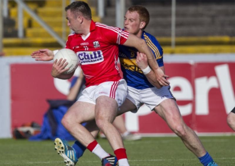 Corks Paul Kerrigan is challenged by Tipperary midfielder George Hannigan in last Saturday nights Munster senior football championship game in P�irc U� Chaoimh.