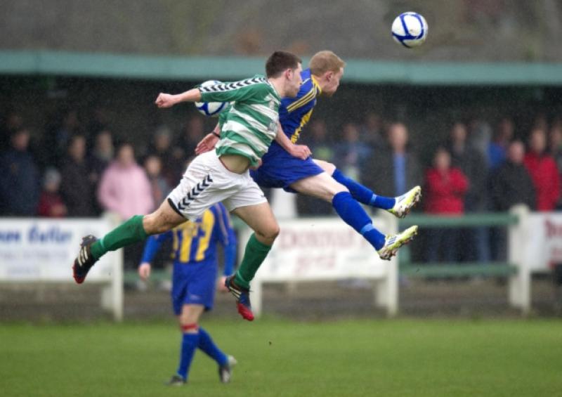 Dave Dineen (Park United) and David Slattery (St. Michaels) flying through the Cooke Park air on Sunday last.