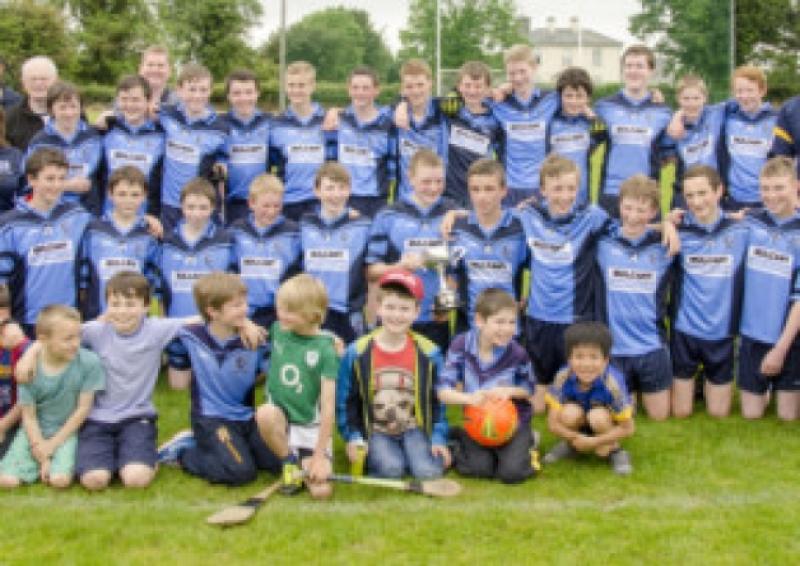 The Moyle Rovers under 14 team with mentors, mascots and supporters celebrate following their county under 14 'A' win over Moycarkey/Borris in Boherlahan.