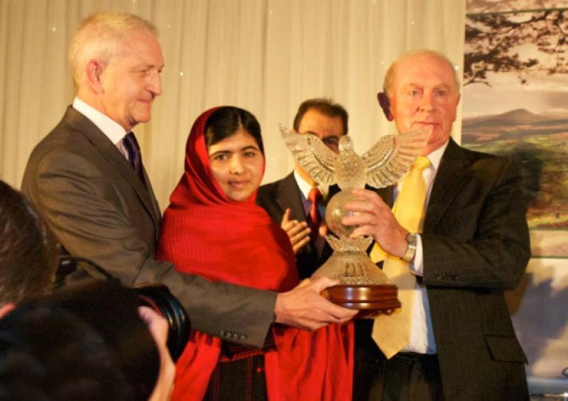Pakistani student Malala Yousafzai receiving the Tipperary International Peace Prize from Peace Convention Chairman Joe Quinn and Secretary, Martin Quinn