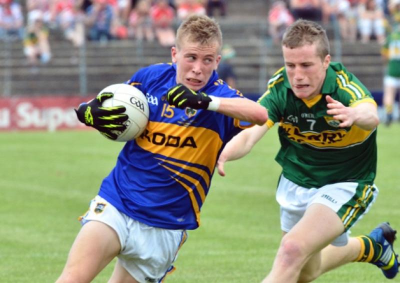 Tipp's Paul Maher about to be tackled by Robert Wharton of Kerry during the Munster MFC final in Killarney last Sunday.