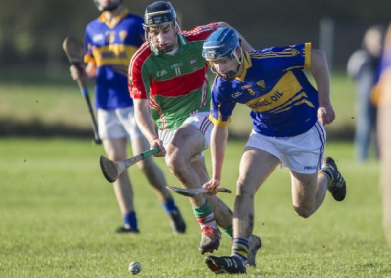 Kilsheelan-Kilcashs Paul Maher and Loughmore-Castleineys John McGrath in a race for possession.