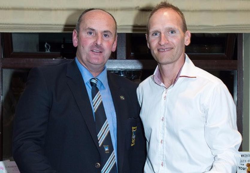 Winner Declan Quinlan receiving his prize from Captain Ed Kelly.