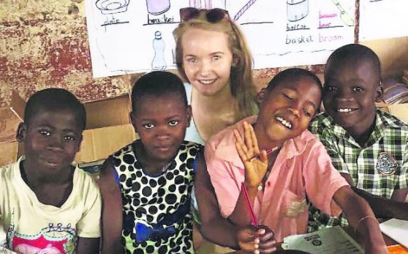 Maeve pictured with some happy smiling pupils